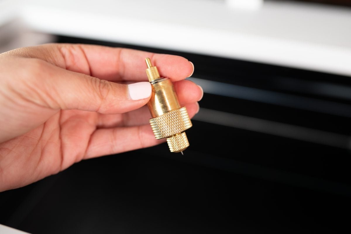 xtool-m1-review-18 Hand holding gold blade housing.